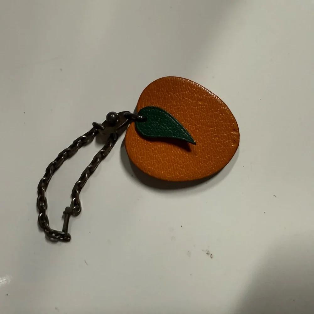 Hermes- AUTHENTIC 🍀 Orange Leather Fruit Charm with Green Leaf